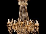 a large antique chandelier with many lights hanging from the ceiling