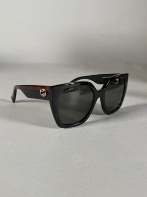 gros plan d'une paire de lunettes de soleil sur une surface blanche