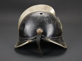 a close up of a helmet on a table with a black background