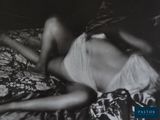 black and white photograph of a woman laying on a bed