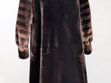 an image of a brown and black striped coat on a mannequin stand
