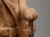 statue of a man with a hat on his head holding a cane