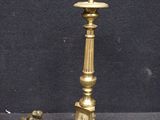 a small statue of a dog next to a candle holder