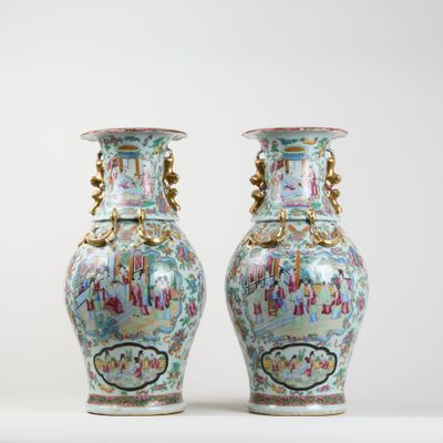 pair of vases sitting on a white surface with a white background