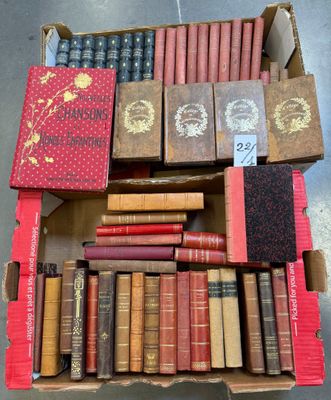 an open box of old books sitting on top of a table