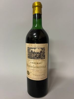 bottle of red wine with a gold cap on a white background