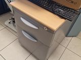 a computer desk with a keyboard and a box on top of it