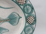 a blue and white plate with a fish design on it