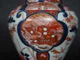 a vase with a floral design on it sitting on a table