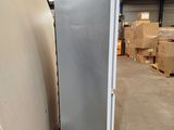 a refrigerator that is sitting in a warehouse next to a pallet