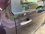 a close up of a car door handle with a sticker on it