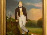 portrait of a boy in a brown jacket and white pants with a golf club