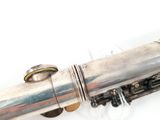 a silver pipe that is sitting on top of a white table