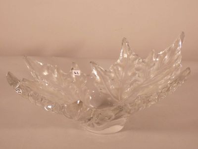 a glass bowl that has a leaf design on it