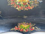 a black table with a gold and red design on it