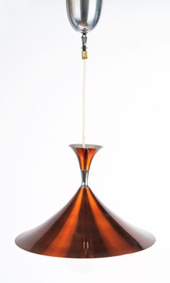 an image of a copper colored pendant light hanging from a ceiling
