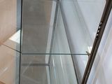 a glass display case in the corner of a room
