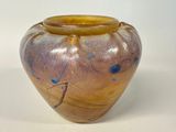 a vase that is sitting on a white surface