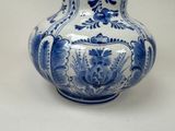 a blue and white vase sitting on a table