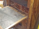 a wooden desk with a drawer on top of it