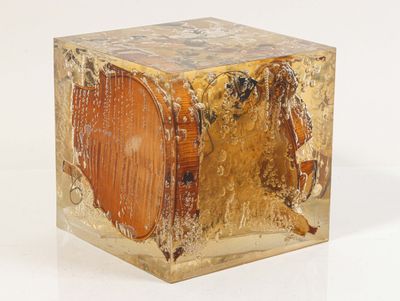 a gold colored box sitting on a white surface