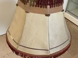 a lamp that is sitting on the floor next to a wall