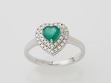 an emerald and diamond heart ring