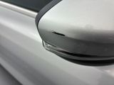 a close up of a car ' s side mirror with a hole in it