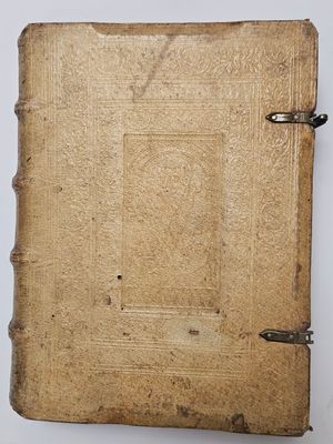 a close up of an old book on a white surface