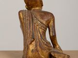 a close up of a statue of a person sitting on a table