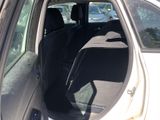 the back seat of a car with the door open in a parking lot