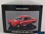 the box is open to show the model of a red car