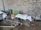 a pile of junk in a room with a brick wall