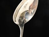 a silver spoon with a picture of a man on it