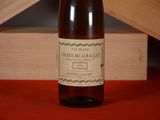 a bottle of wine sitting on a table next to a wooden box