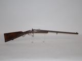 a rifle on a white surface with a white background