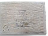 an old envelope with some writing on it sitting on top of a table