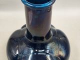 a blue vase that is sitting on a table