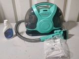 a vacuum that is sitting on a table next to a bottle of water