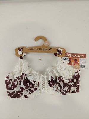bralette with floral print and wooden hanger on white background