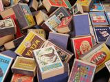 a pile of matchboxes sitting on top of a table