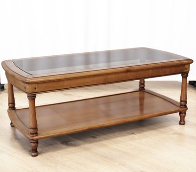 a wooden table with a glass top on a hard wood floor