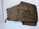 brown cordurope pants laying on a bed with a tag on it