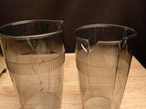 two cups that are sitting on a wooden table