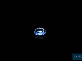 a blue diamond in the dark with a reflection on the surface