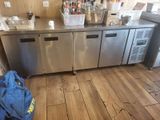 a stainless steel counter with a blue bag in front of it