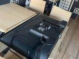 a table with a laptop on top of it in a room