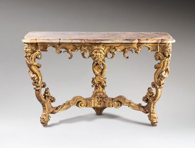 an ornately carved console table with marble top