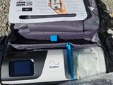 a bag with a cell phone inside of it on the ground