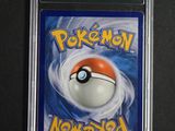 a close up of a pokemon card on a black surface
